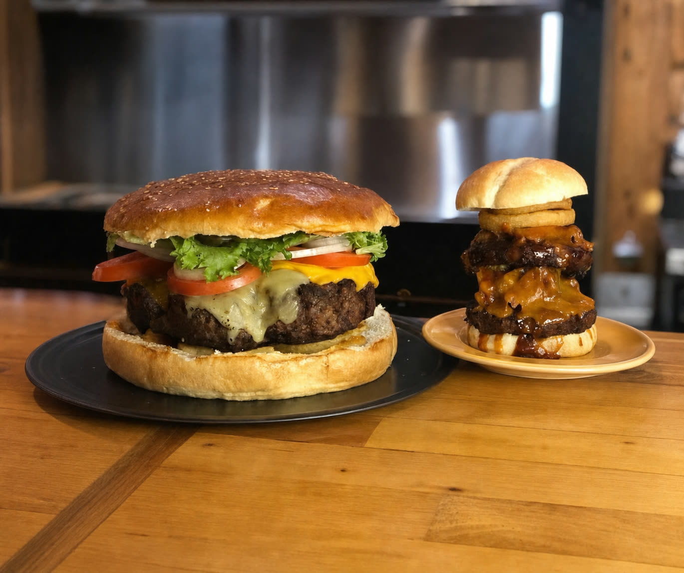 The Feud 5 lb burger challenge at Buffalo Trail — giant cheeseburger on a black plate next to a stacked regular burger for scale