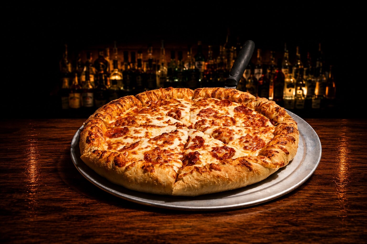 House-made hand-tossed pizza on a metal tray at the Buffalo Trail bar
