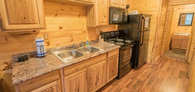 Kitchen with oven, refrigerator and microwave